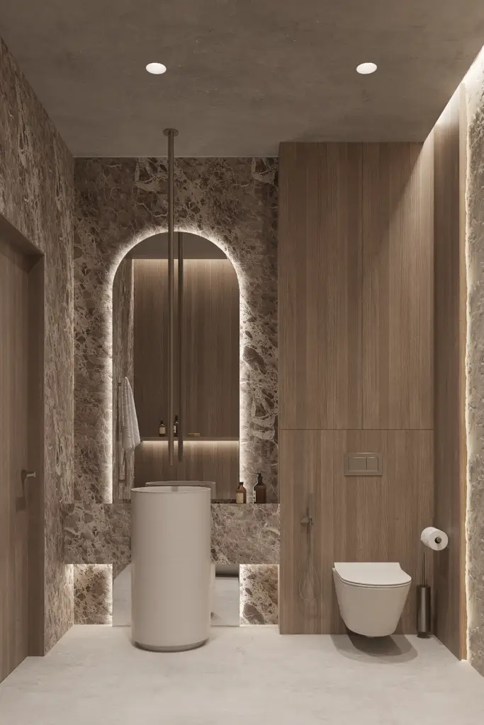Japandi bathroom design with marble walls, arched mirror, and freestanding sink in natural tones
